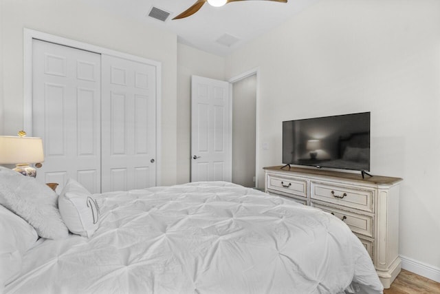 10245 SW Reggiani Rd, Port Saint Lucie, FL 34986 - bedroom with a ceiling fan, visible vents, light wood-type flooring, baseboards, and a closet