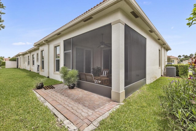 10245 SW Reggiani Rd, Port Saint Lucie, FL 34986 - back of house with a sunroom, ceiling fan, a lawn, and central air condition unit