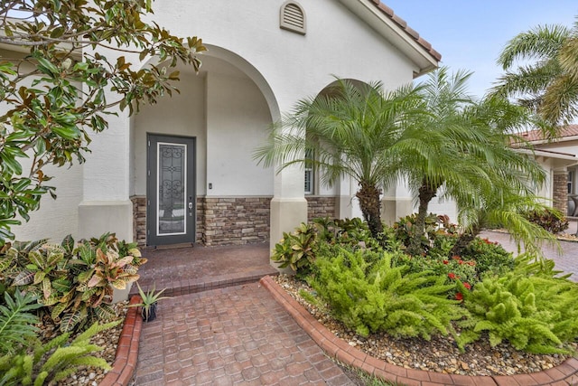 10245 SW Reggiani Rd, Port Saint Lucie, FL 34986 - property entrance featuring stone siding and stucco siding