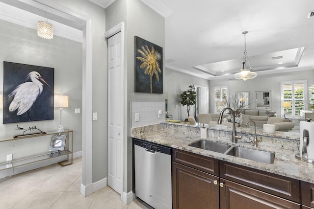 10245 SW Reggiani Rd, Port Saint Lucie, FL 34986 - kitchen with stainless steel dishwasher, a sink, crown molding, and dark brown cabinetry
