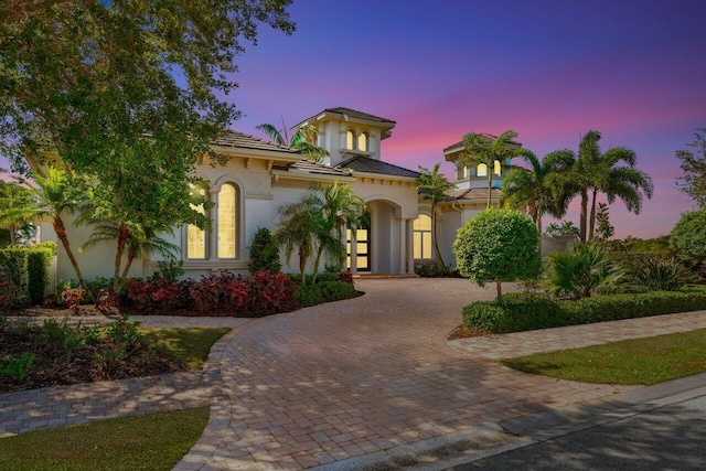 118 SE Mira Lavella, Port Saint Lucie, FL 34984 - mediterranean / spanish-style home with curved driveway, stucco siding, and french doors