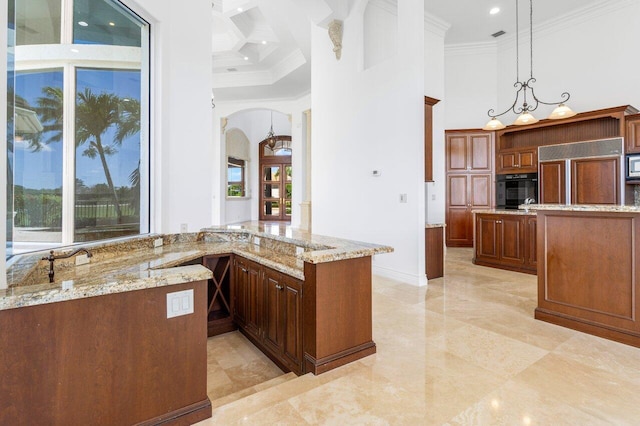 kitchen with crown molding, built in appliances, arched walkways, and a towering ceiling