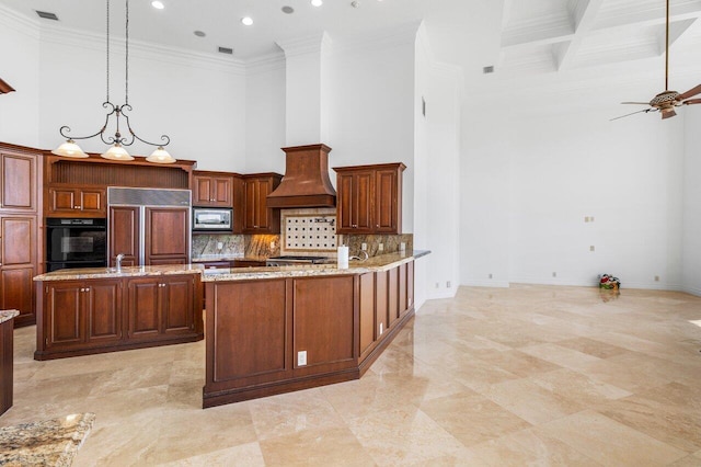 kitchen featuring built in appliances, a high ceiling, visible vents, and custom exhaust hood