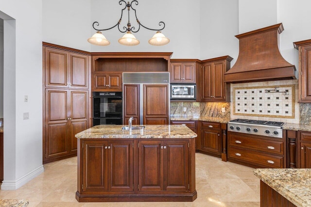 kitchen featuring custom range hood, a sink, a towering ceiling, and built in appliances