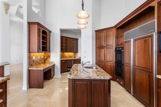 kitchen with a sink, a high ceiling, paneled built in fridge, and wine cooler