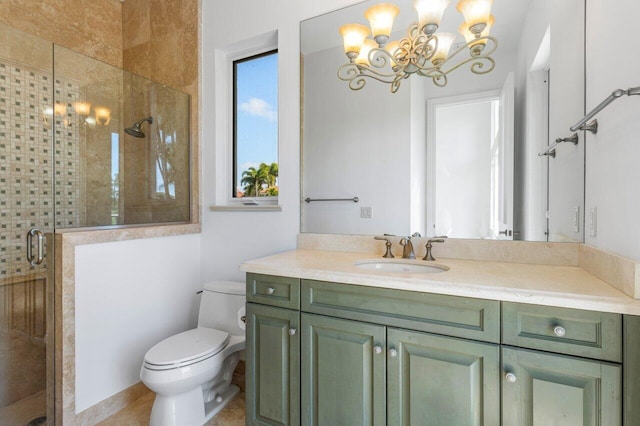 bathroom featuring toilet, a chandelier, a shower stall, and vanity