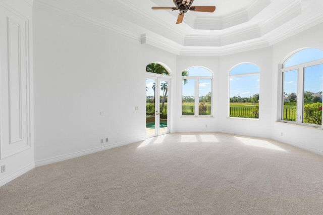 spare room with french doors, ornamental molding, carpet, and ceiling fan