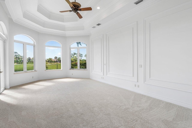 spare room with crown molding, ceiling fan, and carpet