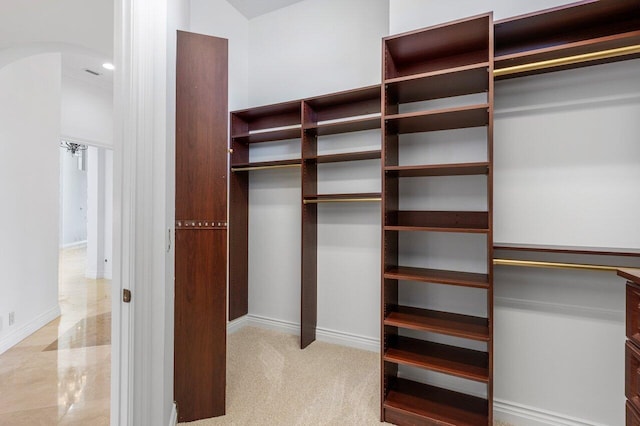 walk in closet with arched walkways