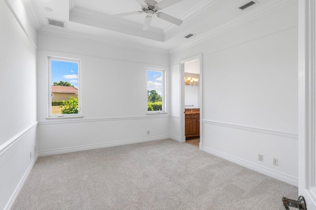 spare room featuring visible vents, ornamental molding, and light colored carpet