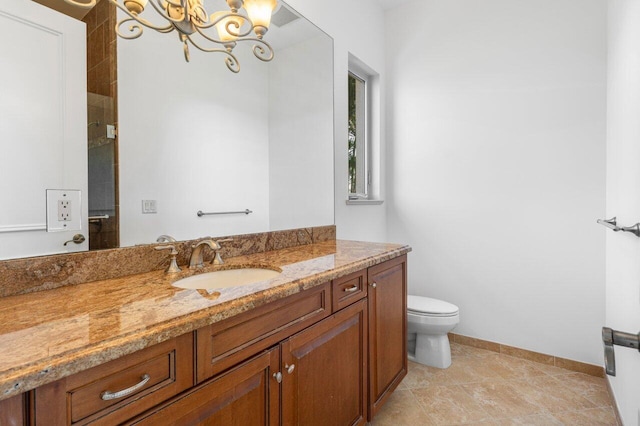 bathroom with toilet, baseboards, a notable chandelier, and vanity