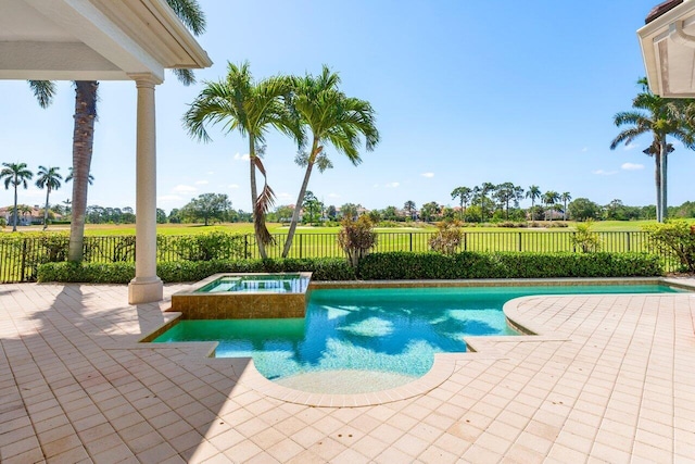 outdoor pool with a fenced backyard, an in ground hot tub, and a patio area