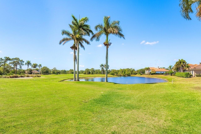 surrounding community featuring a lawn and a water view