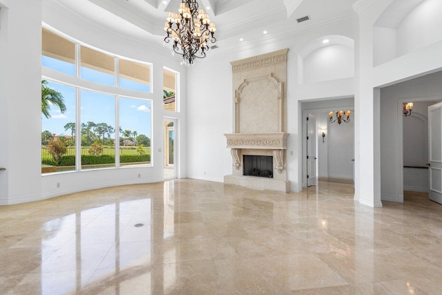 unfurnished living room featuring crown molding, marble finish floor, a high ceiling, and a notable chandelier