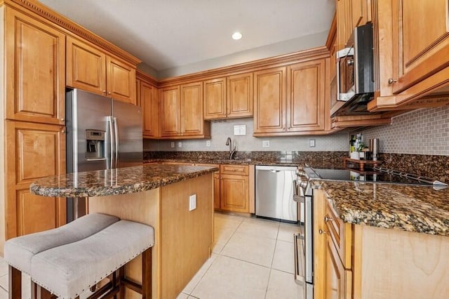 8292 NW 9th Ave, Boca Raton, FL 33487 - kitchen featuring appliances with stainless steel finishes, a sink, light tile patterned flooring, brown cabinetry, and a center island