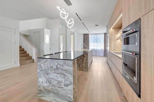 5607 NW 24th Ter, Boca Raton, FL 33496 - kitchen featuring a large island, light wood-style flooring, modern cabinets, and light brown cabinetry