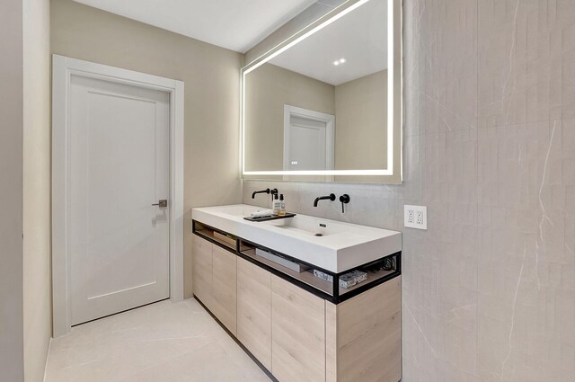 5607 NW 24th Ter, Boca Raton, FL 33496 - bathroom featuring a sink, tile walls, and double vanity