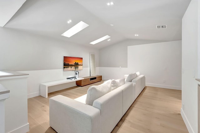 5607 NW 24th Ter, Boca Raton, FL 33496 - living area featuring visible vents, light wood-style flooring, lofted ceiling with skylight, and baseboards
