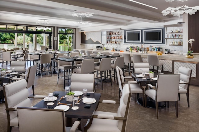 5607 NW 24th Ter, Boca Raton, FL 33496 - dining area featuring indoor wet bar and a notable chandelier