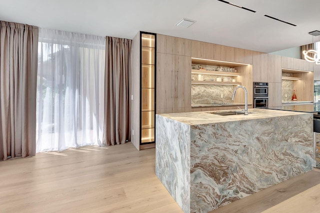 5607 NW 24th Ter, Boca Raton, FL 33496 - bar with visible vents, pendant lighting, light wood-type flooring, black electric cooktop, and a sink