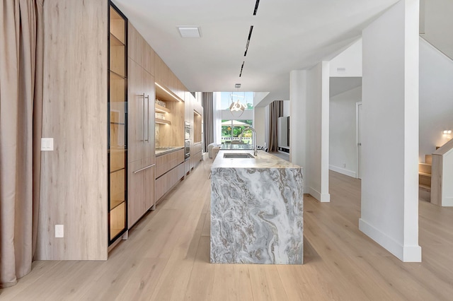 5607 NW 24th Ter, Boca Raton, FL 33496 - kitchen featuring a sink, light brown cabinetry, modern cabinets, and light wood-type flooring
