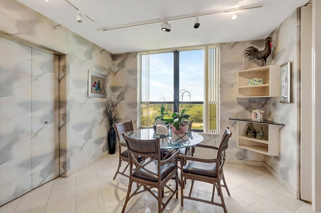 7578 Regency Lake Dr Unit 702, Boca Raton, FL 33433 - dining space featuring track lighting, light tile patterned floors, and baseboards