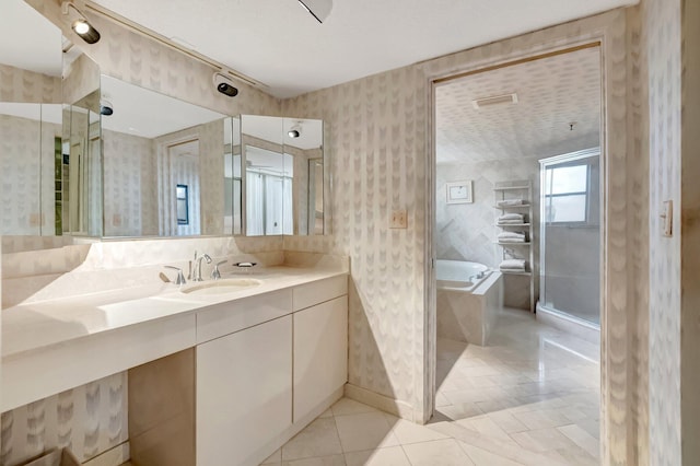 7578 Regency Lake Dr Unit 702, Boca Raton, FL 33433 - bathroom with walk in shower, vanity, tile patterned flooring, a garden tub, and wallpapered walls
