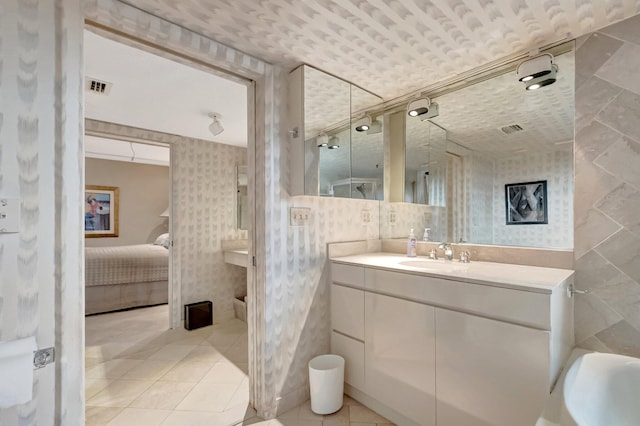 7578 Regency Lake Dr Unit 702, Boca Raton, FL 33433 - ensuite bathroom with vanity, ensuite bathroom, wallpapered walls, and visible vents