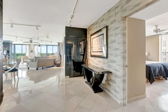 7578 Regency Lake Dr Unit 702, Boca Raton, FL 33433 - corridor with track lighting, baseboards, and light tile patterned flooring