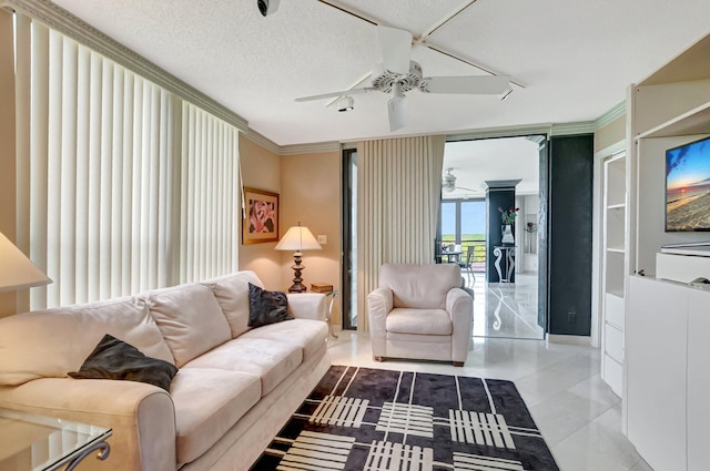 7578 Regency Lake Dr Unit 702, Boca Raton, FL 33433 - living area with a textured ceiling, baseboards, ceiling fan, tile patterned flooring, and crown molding