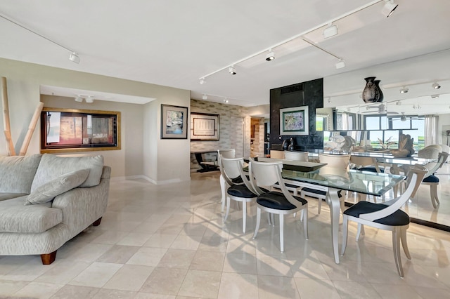 7578 Regency Lake Dr Unit 702, Boca Raton, FL 33433 - dining space with baseboards, an accent wall, and track lighting