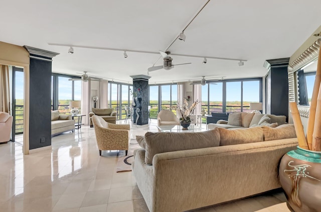 7578 Regency Lake Dr Unit 702, Boca Raton, FL 33433 - living room with rail lighting, expansive windows, plenty of natural light, and a ceiling fan