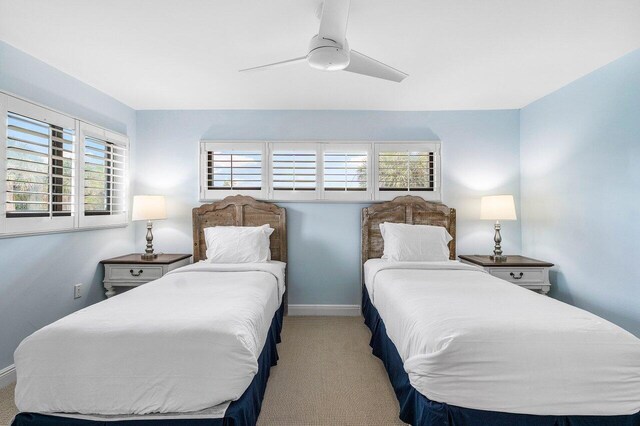 4107 Kittiwake Ct Kittiwake, Unit Kittiwake, Boynton Beach, FL 33436 - carpeted bedroom featuring multiple windows, baseboards, and ceiling fan