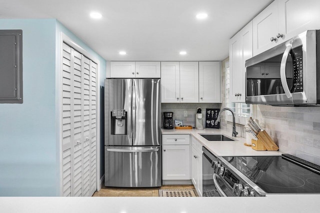 4107 Kittiwake Ct Kittiwake, Unit Kittiwake, Boynton Beach, FL 33436 - kitchen featuring stainless steel appliances, a sink, decorative backsplash, electric panel, and recessed lighting