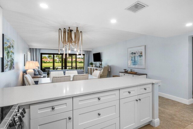 4107 Kittiwake Ct Kittiwake, Unit Kittiwake, Boynton Beach, FL 33436 - kitchen with open floor plan, light countertops, white cabinets, stainless steel range, and recessed lighting