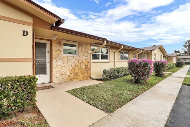 2852 W Crosley Dr W Unit D, West Palm Beach, FL 33415 - view of home's exterior with stucco siding and stone siding