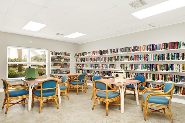2852 W Crosley Dr W Unit D, West Palm Beach, FL 33415 - sitting room with a drop ceiling and wall of books