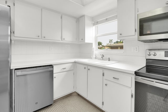 2852 W Crosley Dr W Unit D, West Palm Beach, FL 33415 - kitchen featuring appliances with stainless steel finishes, a sink, backsplash, and light countertops