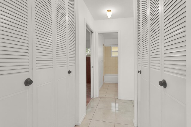 2852 W Crosley Dr W Unit D, West Palm Beach, FL 33415 - hall with light tile patterned floors and baseboards