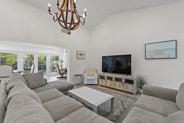 1256 Holly Cove Dr, Jupiter, FL 33458 - living room featuring an inviting chandelier, visible vents, wood finished floors, baseboards, and high vaulted ceiling