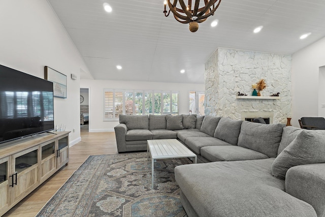 1256 Holly Cove Dr, Jupiter, FL 33458 - living area with recessed lighting, an inviting chandelier, light wood-style flooring, and a fireplace
