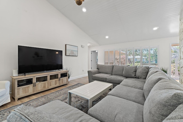 1256 Holly Cove Dr, Jupiter, FL 33458 - living room featuring light wood-type flooring, recessed lighting, baseboards, and high vaulted ceiling