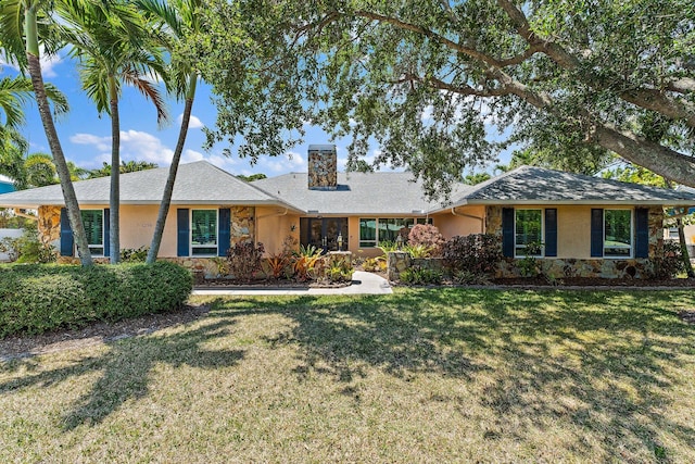 1256 Holly Cove Dr, Jupiter, FL 33458 - ranch-style home featuring a front yard, a chimney, stone siding, and stucco siding