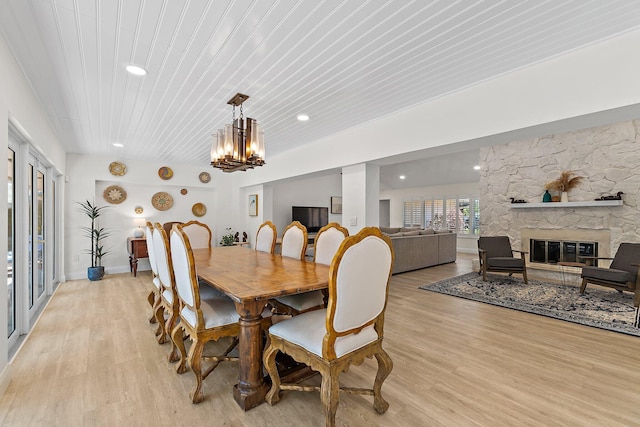 1256 Holly Cove Dr, Jupiter, FL 33458 - dining room with a stone fireplace, recessed lighting, wooden ceiling, light wood finished floors, and a notable chandelier