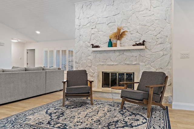 1256 Holly Cove Dr, Jupiter, FL 33458 - living area featuring baseboards, a stone fireplace, and wood finished floors