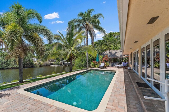 1256 Holly Cove Dr, Jupiter, FL 33458 - outdoor pool with a water view and a patio area