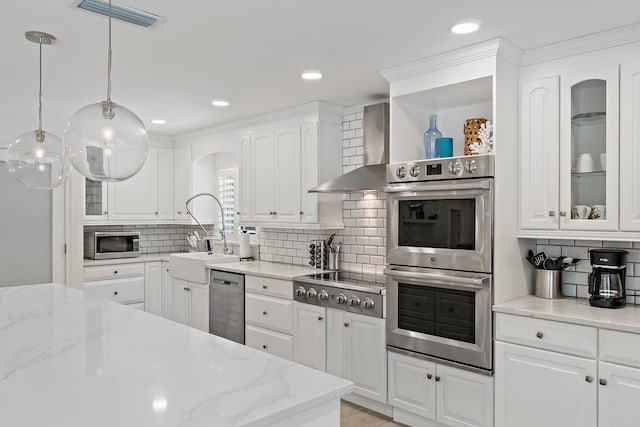 1256 Holly Cove Dr, Jupiter, FL 33458 - kitchen featuring backsplash, visible vents, a sink, stainless steel appliances, and wall chimney exhaust hood