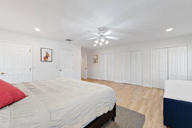 1256 Holly Cove Dr, Jupiter, FL 33458 - bedroom featuring two closets, recessed lighting, light wood-style flooring, and visible vents