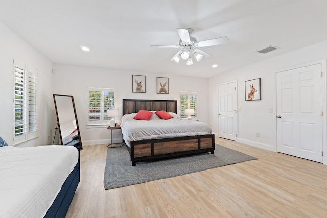 1256 Holly Cove Dr, Jupiter, FL 33458 - bedroom featuring baseboards, multiple windows, light wood finished floors, and visible vents