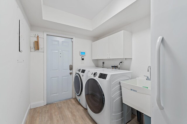 1256 Holly Cove Dr, Jupiter, FL 33458 - laundry area with independent washer and dryer, cabinet space, a sink, baseboards, and light wood finished floors
